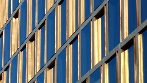Golden window frames on a high office building, with blue sky reflection in Video stock 231990725