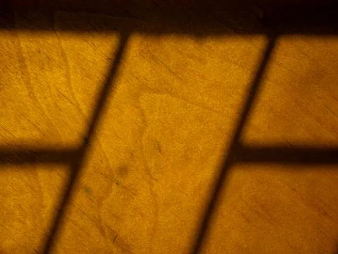 Golden Window Shadow Pattern on Wooden Surface, Warm Light and Shade Abstra.. Stock Photos