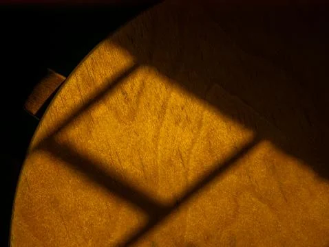 Golden Window Shadow Pattern on Wooden Surface, Warm Light and Shade Abstra.. Stock Photos