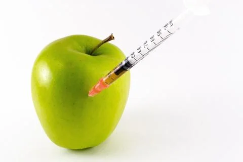 Golden Yellow Apple and Hypodermic Syringe. Stock Photos