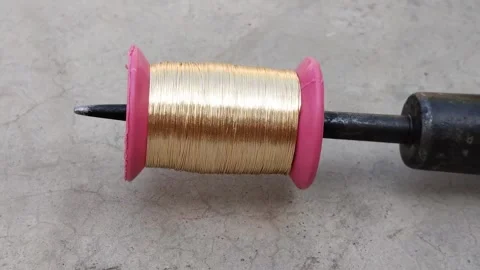 Golden zari thread unrolling for silk border Stock Footage 254528940