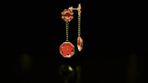 Goldish earrings with red ruby gemstones rotate Stock Footage 197541428