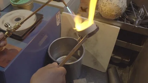 Goldsmith forging gold in machine cast Video stock 82398611