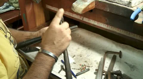 Goldsmith hammering on metal Stock Footage 12019532