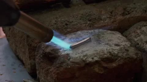 Goldsmith heating silver ring blank with gas torch. Jewelry handicraft Stock Footage 263828268