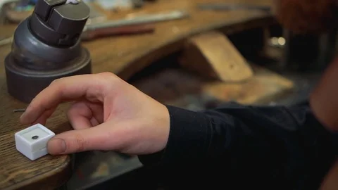 Goldsmith opens the box with the gem and takes it with tweezers Stock-Footage 73553628