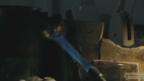 Goldsmith processing gold with torch Stock Footage 180182836