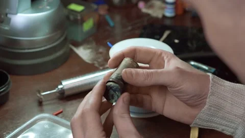 Goldsmith puts the blank of the wax ring into a mold for making jewelry. Stock Footage 147414483