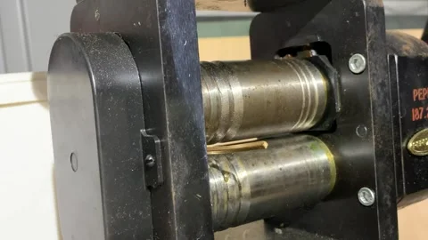Goldsmith rolling a stick of gold through the rolling mill Video stock 242799822