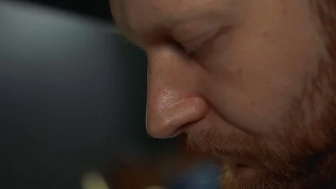 Goldsmith turns the ring and dried enamel on it use an ultraviolet instrument Stock Footage 73813341