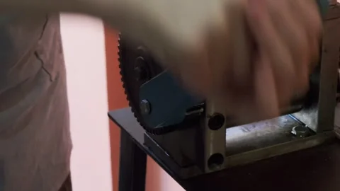 Goldsmith using a press to roll silver ring blank. Close up. Jewelry handicraft Stock Footage 263836253