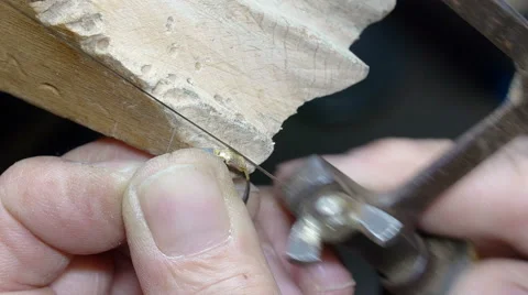 Goldsmith working on a gold ring with a metal saw wire Video stock 51166949