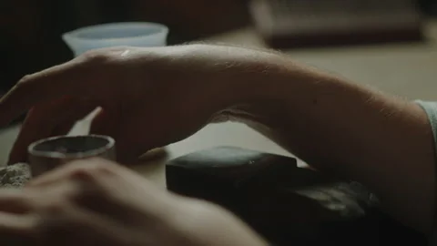 Goldsmith in the workshop creates a mold for making a gold ring by casting gold Stock Footage 260584065