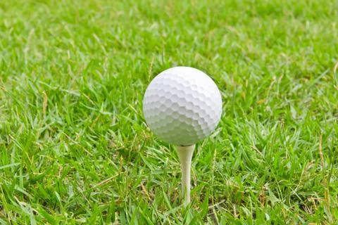 Golf ball and tee grass Stock Photos