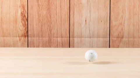 Golf Ball Bouncing on Wooden Surface Stock Footage 308434661