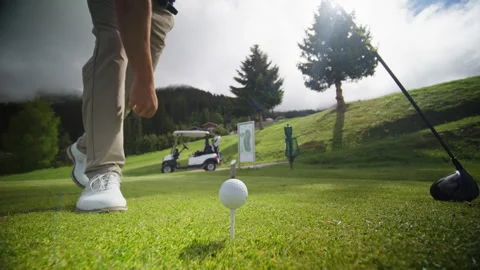 Golf Ball Drops Into Cup on Mountain Green in Verbier Video stock 337603446