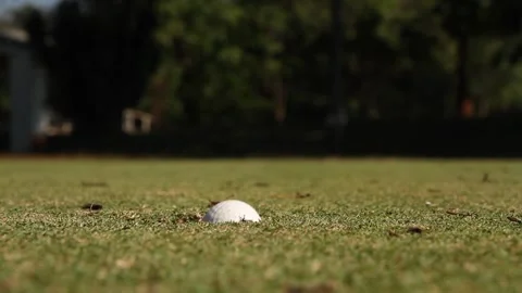 Golf ball falling into hole Stock Footage 283014189