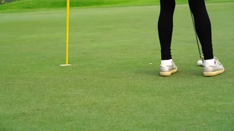 Golf ball on grass behind driver at golf club Stock Footage 154572903