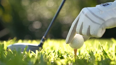 Golf ball on green grass ready to be struck on golf course , slow motion . Stock Footage 129581938