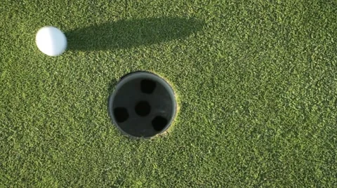 Golf ball in hole Stock Footage