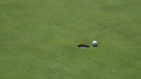 Golf ball to the hole on the green Stock Footage 270725943