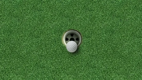 Golf ball in hole on green grass putting surface centered background Video stock 330120805