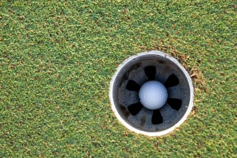 Golf ball in the hole 스톡 사진