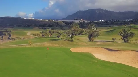 Golf ball lands close to the hole and flag Video stock 74965971