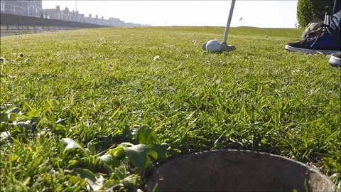 A golf ball missing a hole Stock Footage 77863505