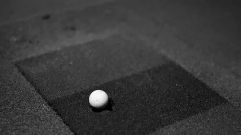 Golf ball motion shot showing putting on artificial green Stock Footage 346637093