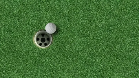 Golf ball next to hole on green grass putting surface wide background Video stock 330120822