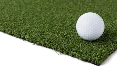 Golf Ball Resting on Section of Artificial Turf Grass On White Background. Stock Photos