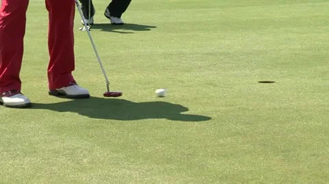 Golf ball rolling into hole Stock Footage 22303582