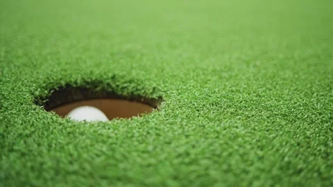 Golf ball rolling toward hole on green grass in slow motion Stock Footage 309514327