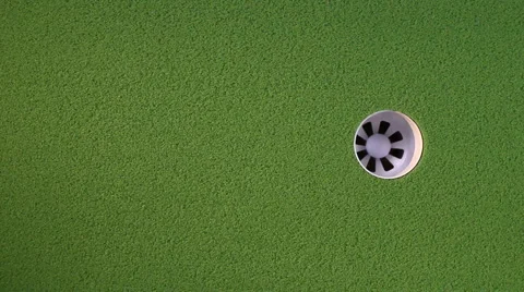 Golf ball rolls into cup Stock Footage