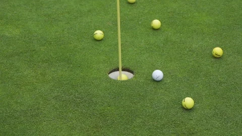 Golf ball rolls past the flag in the hole 스톡 동영상 155363700