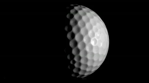 Golf ball rotates against black V2 Stock Footage