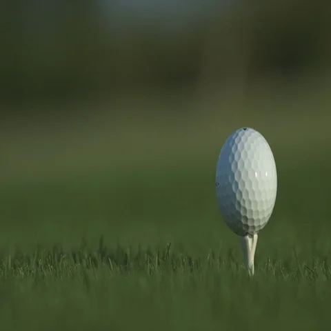 Golf ball standing on a tee before impact Stock Footage 69329345
