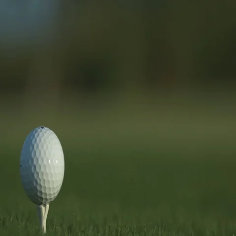 Golf ball standing on a tee before impact Stock Footage 69329416