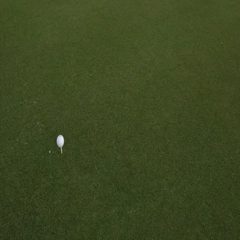 Golf ball standing on a tee before impact Stock Footage 69331910