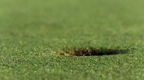 Golf ball stops next to hole Stock Footage 37112840