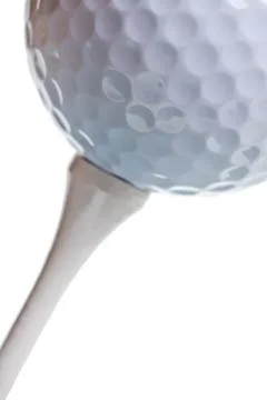 Golf ball on tee isolated Stock Photos