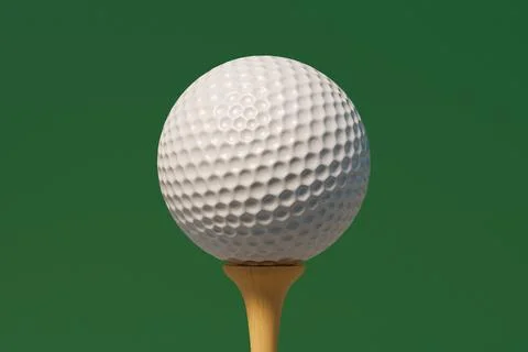 Golf ball on tee ready for play on green background. Stock Photos