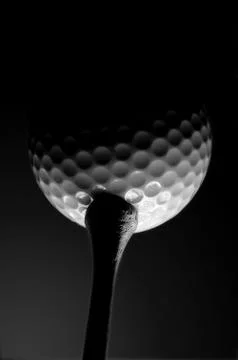 Golf ball on a tee shot from below in black and white Stock Photos