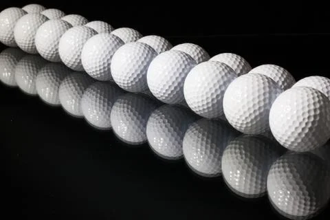 Golf balls on the black background Stock Photos