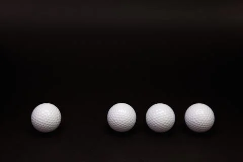 Golf balls on the black table. Stock Photos