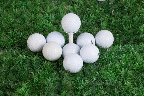 Golf Balls On Green Grass Stock Photos