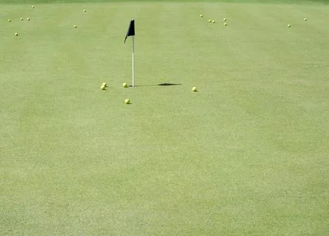 Golf balls on a green in the practice range Fotos de archivo