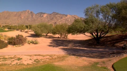 Golf cart riding down path with mountains  Video stock 125278315