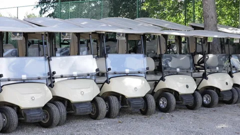 Golf carts are lined up ready for use at a country club. Stock Footage 148038258